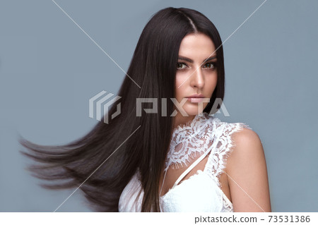 Beautiful brown-haired girl with a perfectly smooth hair, and classic make-up. Beauty face and hair. Beautiful brown-haired girl with a perfectly smooth hair, and classic make-up. Beauty face and hair. 73531386