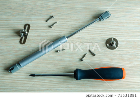 The master assembles and installs a gas-oil lift rack on furniture. 73531881