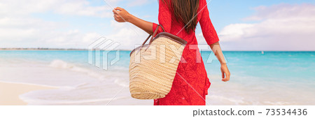 Beach travel vacation tourist lady carrying tote bag fashion holiday accessory. Panoramic banner travel lifestyle Beach travel vacation tourist lady carrying tote bag fashion holiday accessory. Panoramic banner travel lifestyle 73534436