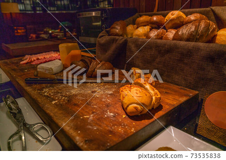 Loafs of freshly baked bread in basket at hotel buffet 73535838