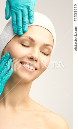 Female derma rejuvenate treatment. Doctor glove touch woman face. Cosmetolog 73535959