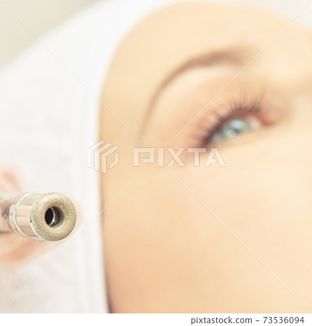 Cosmetology face treatment. Patient young girl. Salon cosmetic hardware. Dermatology diamond skin clean 73536094