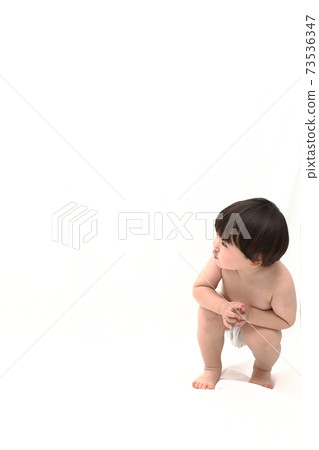 nudist toddler Portrait of a naked toddler playing in the hamper - SuperStock