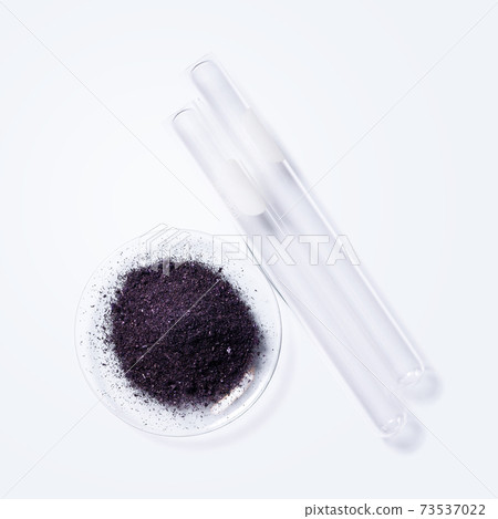 Potassium permanganate (KMnO4) and test tube on white laboratory table. Potassium permanganate (KMnO4) and test tube on white laboratory table. 73537022