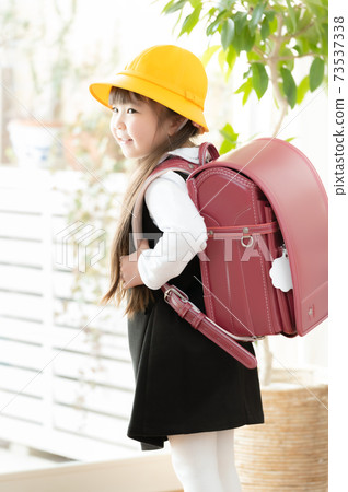 Elementary school student carrying a school bag - Stock