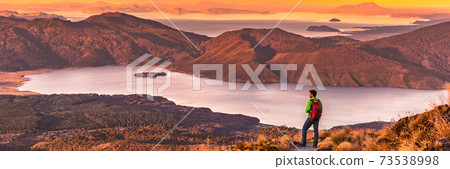 Travel hiking man looking at nature landscape sunset panoramic banner background. Adventure traveler in outdoor New Zealand, backpacking hiker. Copy space panorama Travel hiking man looking at nature landscape sunset panoramic banner background. Adventure traveler in outdoor New Zealand, backpacking hiker. Copy space panorama 73538998
