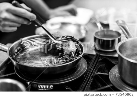 Chef cooking in a kitchen, chef at work, Black and White. Chef cooking in a kitchen, chef at work, Black and White. 73540902