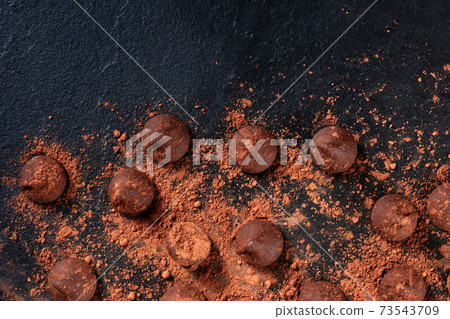 Chocolate truffles, shot from above on a black background 73543709