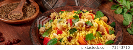Couscous panorama with ingredients on a dark rustic wooden background 73543710