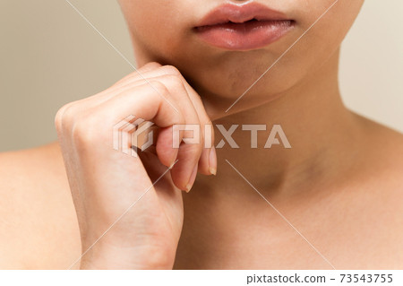 Woman pinching her chin Woman pinching her chin 73543755