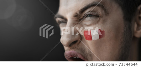 A screaming man with the image of the Peru national flag on his face A screaming man with the image of the Peru national flag on his face 73544644