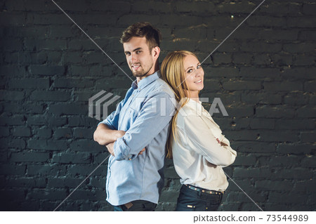 business team male and female formed of young businessmen standing over a dark background business team male and female formed of young businessmen standing over a dark background 73544989