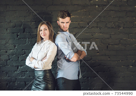 business team male and female formed of young businessmen standing over a dark background 73544990