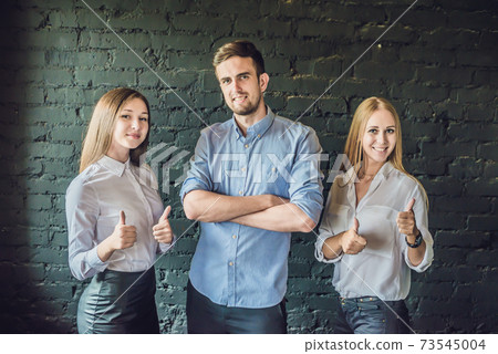 business team male and female formed of young businessmen standing over a dark background business team male and female formed of young businessmen standing over a dark background 73545004