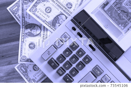 Old fashioned calculator and dollars 73545106