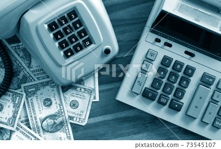 Old fashioned calculator, telephone and dollars Old fashioned calculator, telephone and dollars 73545107