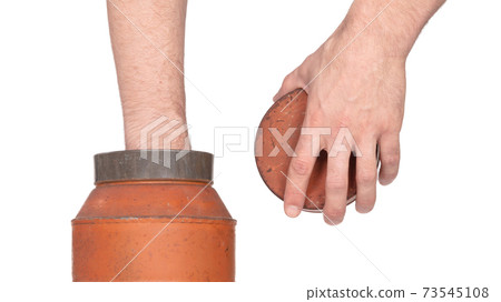 Hand in old nostalgic can isolated on white 73545108