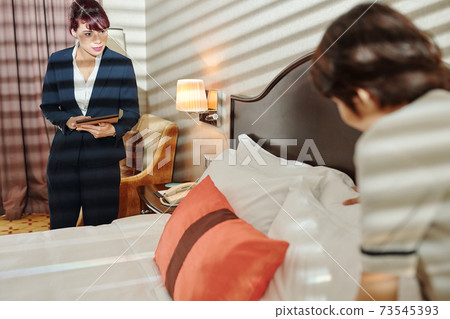 Hotel manager controlling work Hotel manager controlling work 73545393