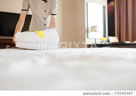 Maid preparing room for guests Maid preparing room for guests 73545397