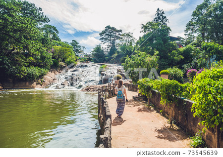 Young woman on the background of Beautiful Camly waterfall In Da Lat city Young woman on the background of Beautiful Camly waterfall In Da Lat city 73545639