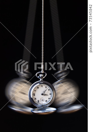 Swinging pocket watch hypnosis on black 73545842