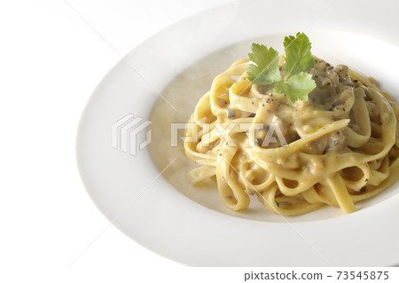 Photographed flat pasta with hot truffle cream with trefoil on a white background 73545875