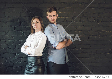 business team male and female formed of young businessmen standing over a dark background business team male and female formed of young businessmen standing over a dark background 73546754