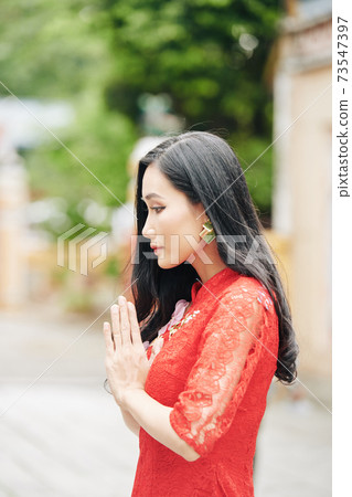 Praying young woman Praying young woman 73547397