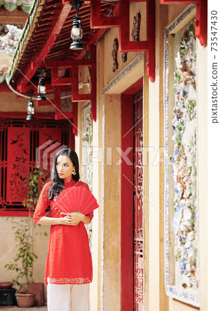 Woman at temple doors Woman at temple doors 73547430