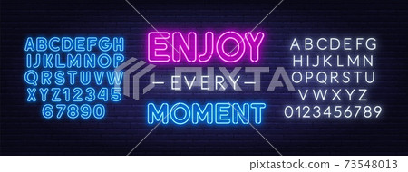 Enjoy every moment neon inspirational quote on a brick wall. 73548013