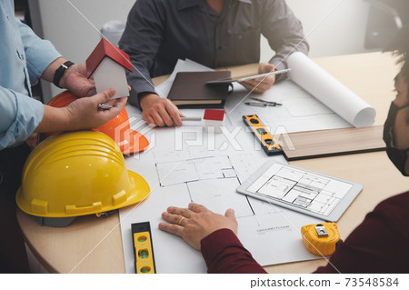 Engineer and Architect concept, Engineer Architects and Interior designer working with blueprints Engineer and Architect concept, Engineer Architects and Interior designer working with blueprints 73548584