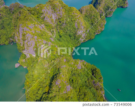 Aerial view panorama of floating fishing village and rock island, Halong Bay, Vietnam, Southeast Asia. UNESCO World Heritage Site. Junk boat cruise to Ha Long Bay. Popular landmark of Vietnam 73549006