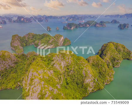 Aerial view panorama of floating fishing village and rock island, Halong Bay, Vietnam, Southeast Asia. UNESCO World Heritage Site. Junk boat cruise to Ha Long Bay. Popular landmark of Vietnam 73549009