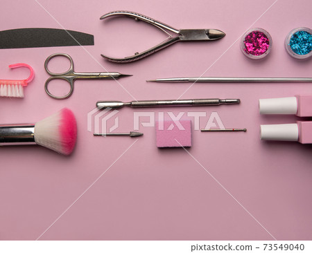 Set of manicure tools and accessories on a pink background. Hardware manicure,Flat lay. 73549040