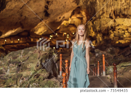 Woman tourist in Hang Sung Sot Grotto Cave of Surprises, Halong Bay, Vietnam Woman tourist in Hang Sung Sot Grotto Cave of Surprises, Halong Bay, Vietnam 73549435