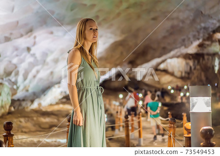 Woman tourist in Hang Sung Sot Grotto Cave of Surprises, Halong Bay, Vietnam Woman tourist in Hang Sung Sot Grotto Cave of Surprises, Halong Bay, Vietnam 73549453