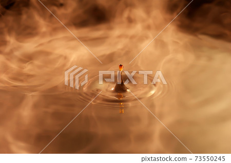 Ripples of water drops brown coffee 73550245