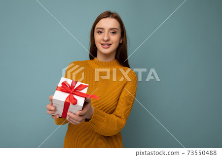 Beautiful happy young brunette woman isolated over colourful background wall wearing stylish casual 73550488