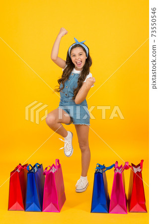 Happy cheerful Girl shopping. Fashion shop. Little girl  73550546
