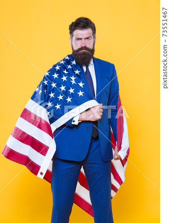 The flag is his pride. Bearded man holding american flag  73551467
