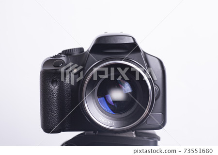 Digital photo camera on black tripod isolated on white background Digital photo camera on black tripod isolated on white background 73551680