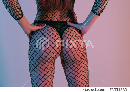 Sexy female back in black lingerie and fishnet isolated over background. Sexy female back in black lingerie and fishnet isolated over background. 73551883