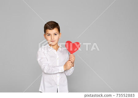 valentine's day. cute little child boy holding red heart 73552883