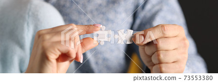 Man and woman connect white puzzles closeup Man and woman connect white puzzles closeup 73553380