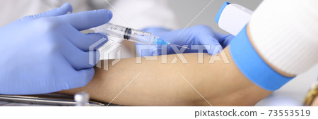 Doctor injecting medication into patients ulnar vein at clinic closeup Doctor injecting medication into patients ulnar vein at clinic closeup 73553519
