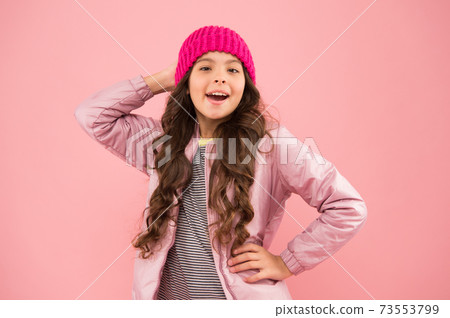Winter activities. little girl puffer jacket and knitted hat.  73553799