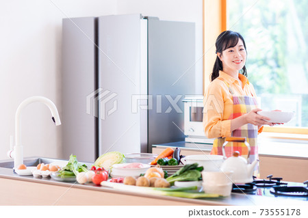 Middle housewife and ingredients in the kitchen Middle housewife and ingredients in the kitchen 73555178