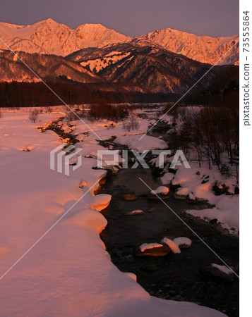 The Hakuba Sanzan mountains and the Matsukawa River, part of the Himekawa River system, shining in the morning glow in winter [Hakuba Village, Nagano Prefecture] 73555864