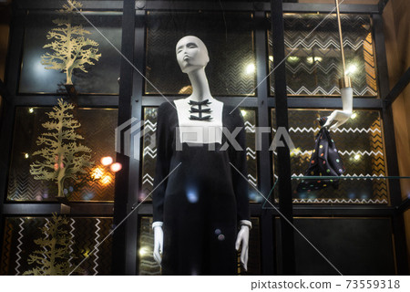 mannequins on a shop window in a black and white dress 73559318
