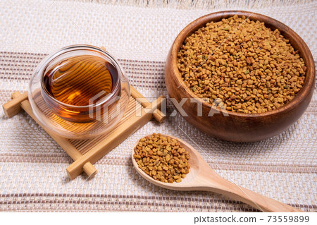 Fenugreek Seeds or MethiDana drink by speaking it in water overnight. close up 73559899